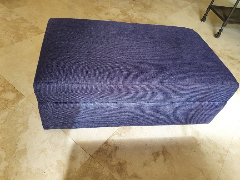 Navy blue Crate and Barrel ottoman with the storage