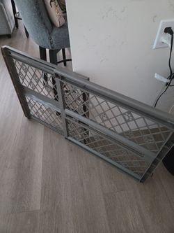 Two Gray adjustable pressurized dog gate
