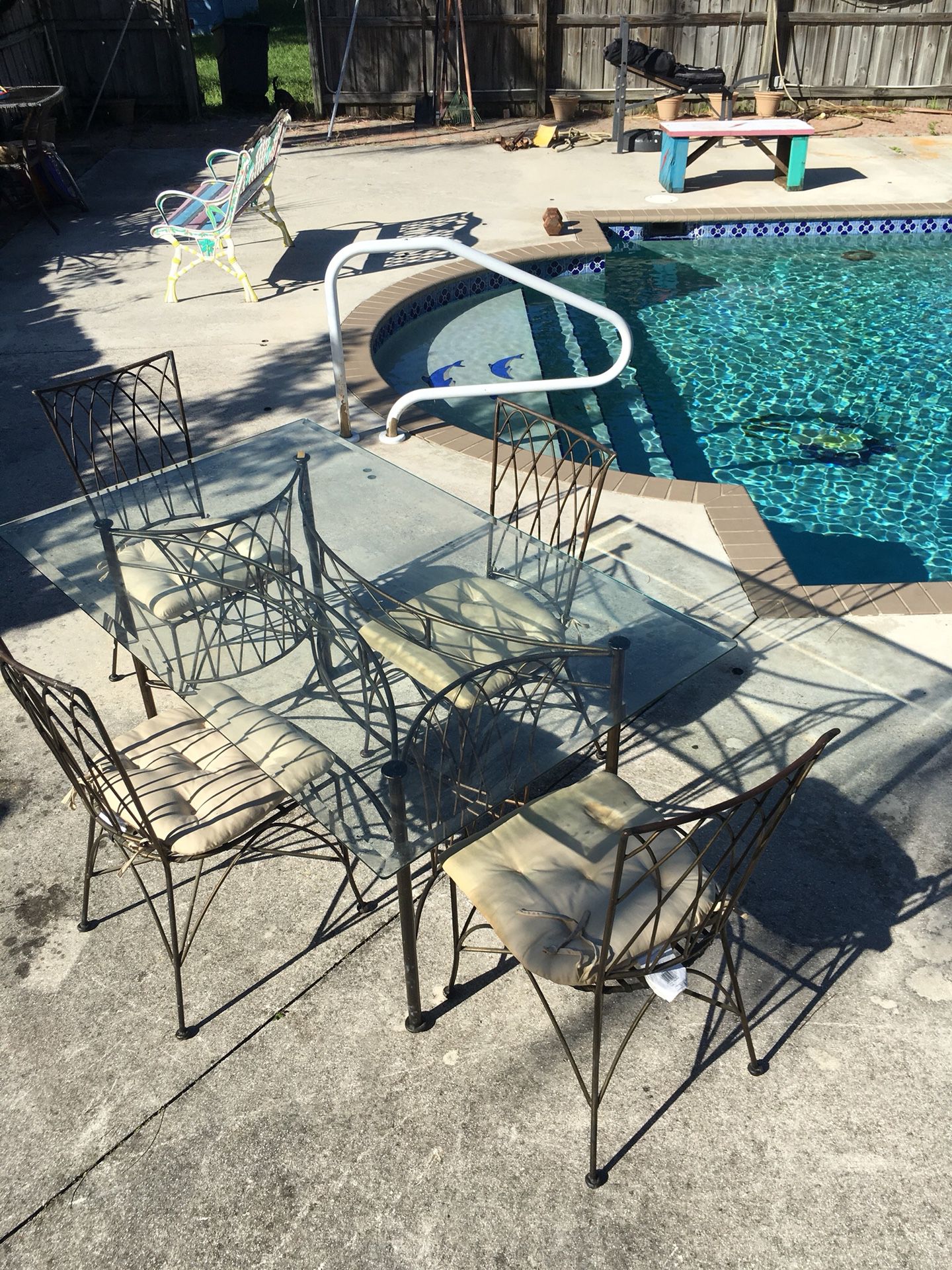 5 foot wrought iron glass table and chairs in mint condition