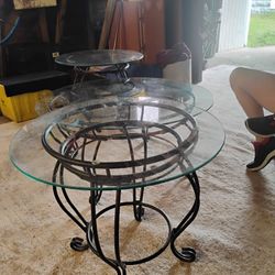 A Glass Top Coffee Table With Wrought Iron Stand And Two Glass Top End Tables With Wrought Iron 