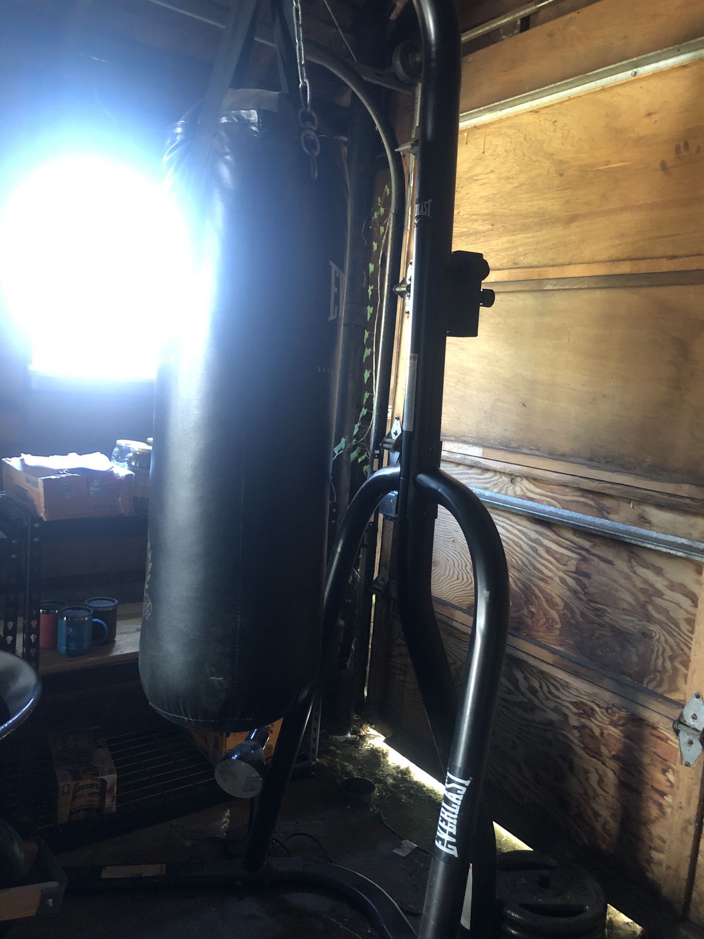 Punching bag, stand, and three 25lb plates for anchoring