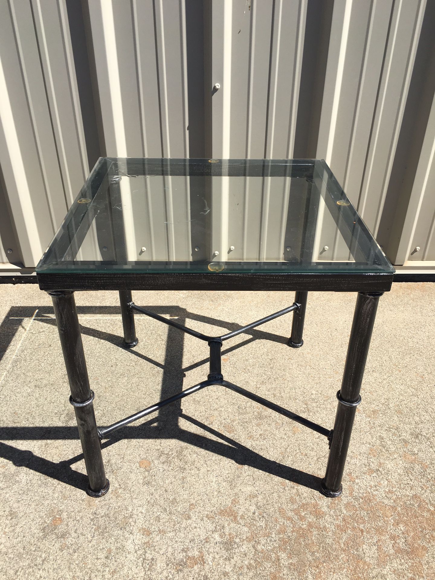 Metal side table with glass top