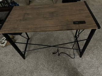 Writing or computer desk with a built-in power strip with AC and USB outlets