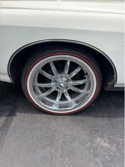 20 “ chrome riddler rims on red stripe Vouge tires