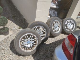4 x 15" aluminum rims with tires Ford