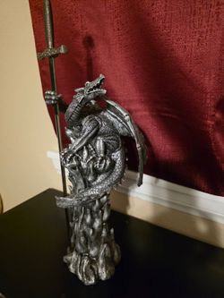 Dragon Statue With Sword and a Wizard With a Dragon Statue