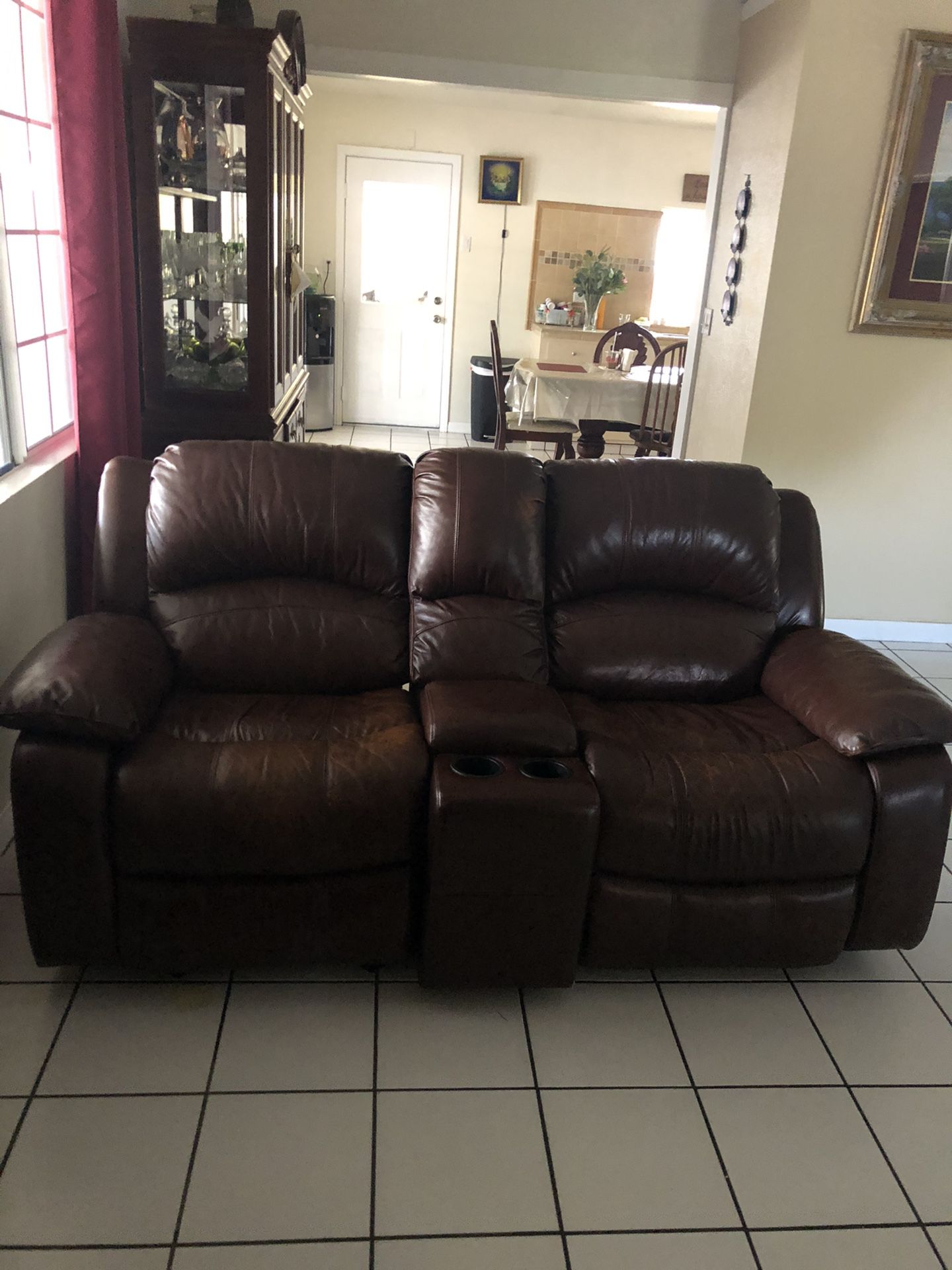 Brown leather couch that is reclining