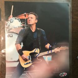 Bruce Springsteen playing the guitar 8” x 10” photo with autograph and COA blue with a sharpie is the autograph