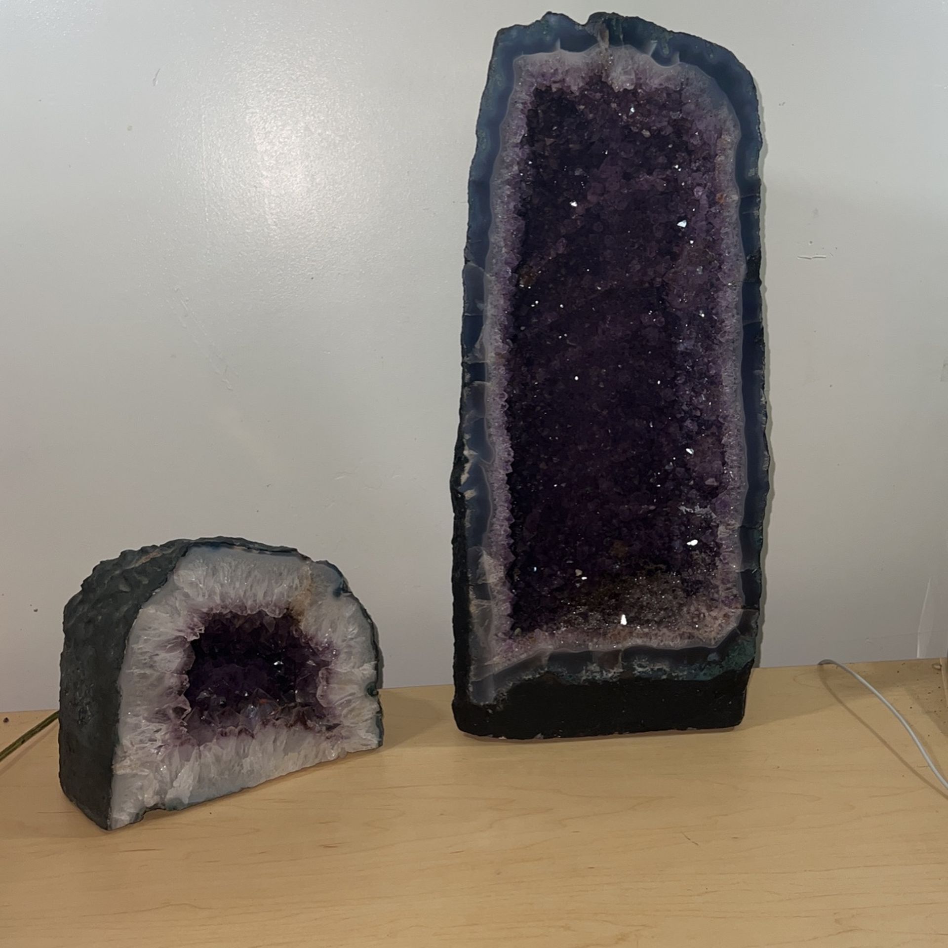 Set of two purple amethyst crystal geodes