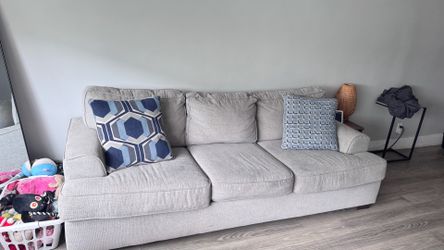 Gray pullout couch w/ two pillows