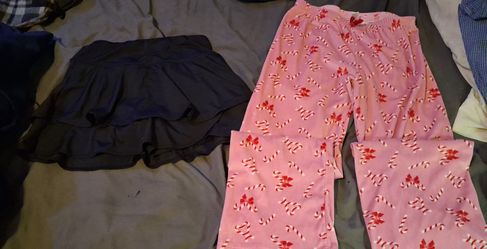 1pr of women's stretchy pants, 1 pr of pink colored pj pants, 1 black colored mini skort size medium