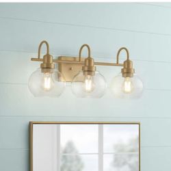 Home Decorators Collection Halyn 23 in. 3-Light Vintage Brass Bathroom Vanity Light with Clear Glass Shades