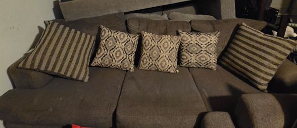 Brown sofa and love seat