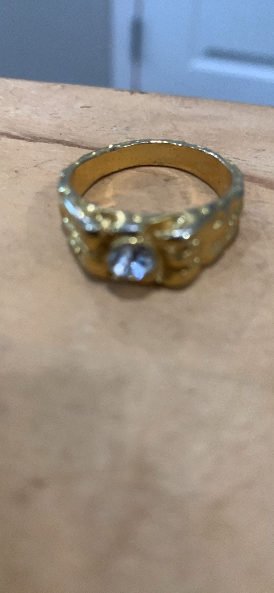 GOLD TONE NUGGET STYLE RING WITH CENTER CLEAR JEWEL