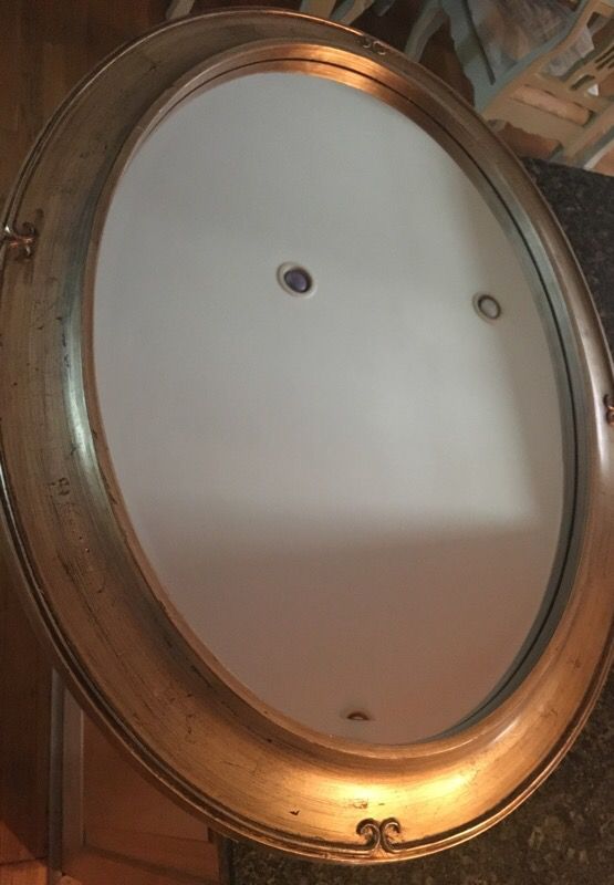 Oval distressed mirror