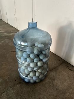 5 gallon container of golfballs