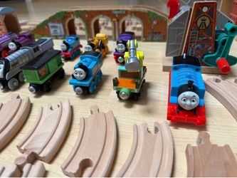 Toy trains, a lot of Thomas the Tank Engine trains and others and a lot of wooden train tracks