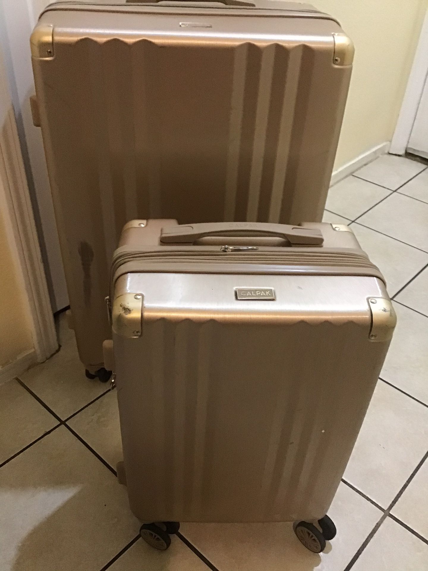Calpak 2pc RoseGold Luggage set / 1 carry-on 22” and 1 large 30” check in used in good condition minor scuff on outside exterior clean inside