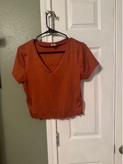 Hearts + Hips burnt orange crop top  V neck with ruffle detail around bottom  Shiny bright color  Size L