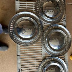 FOUR 1956 15” PLYMOUTH HUBCAPS