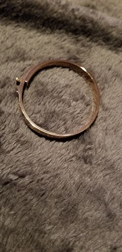 Gold toned hinged bracelet