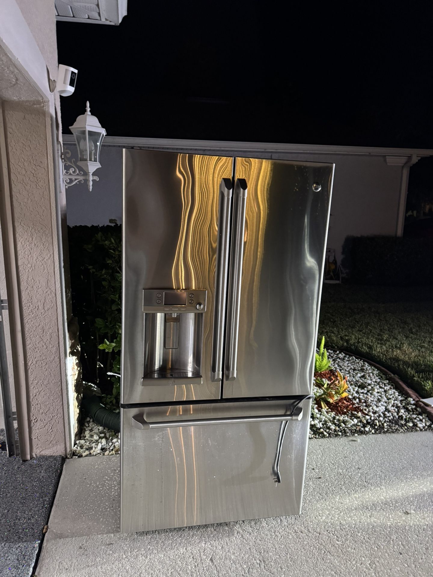 GE General Electric stainless steel French door fridge with a bottom freezer and built-in water/ice