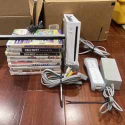 Wii Console With Controller, Motion Detector,  And Some Games 