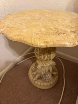 vintage 1970s accent table faux marble top and a plaster base adorned with carved cherubs
