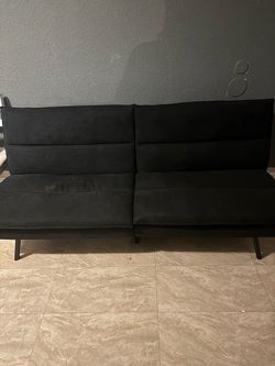 convertible memory foam pillow-top futon sofa bed featuring a split backrest design, plush horizontal tufting, and tapered metal legs.