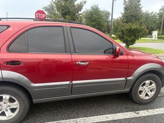 Red Kia SUV with Tinted Windows