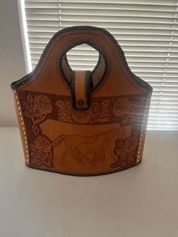 This is a vintage hand-tooled leather purse