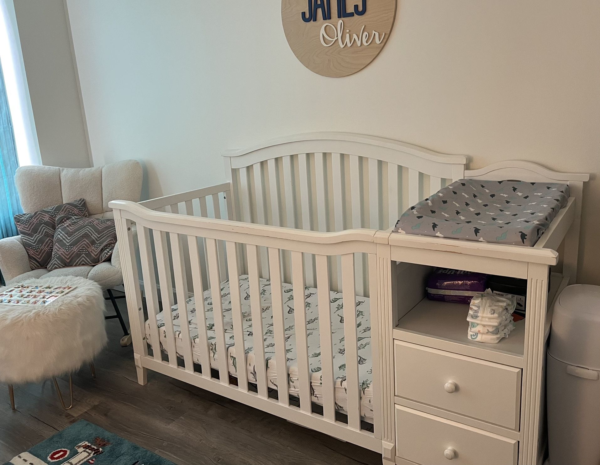 White Baby Crib With Changing Station Attached And Drawers For Storage 