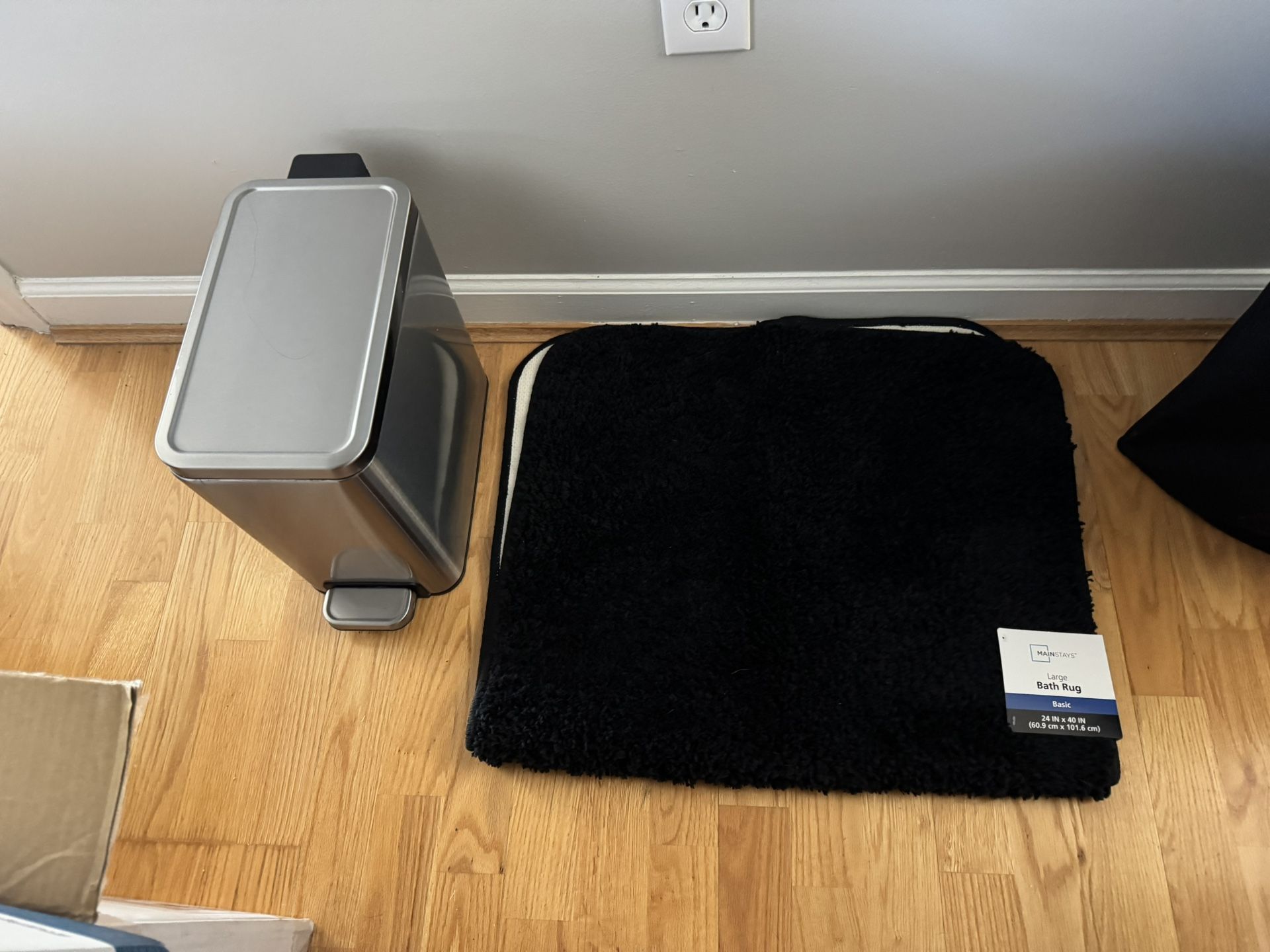 A new bath mat, like New trash can, and a used laundry basket, all for $15