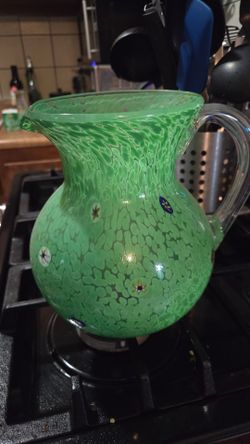 A box of green themed dishes and vases.