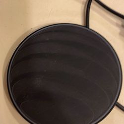 AT&T wireless charging pad.  This device is designed to charge Qi-enabled devices, including both iPhone and Android models. 