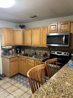 Kitchen cabinets with granite backsplash