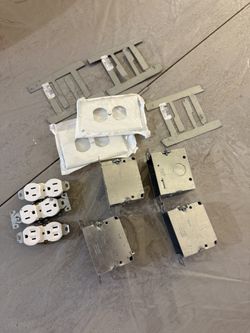 Electrical Outlet and Box Set Includes outlet covers, metal boxes, and outlets.