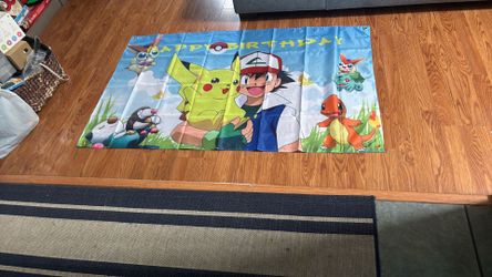 Pokémon birthday banner with party favor bags