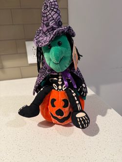 Halloween plush witch sitting on a pumpkin-makes spooky sounds
