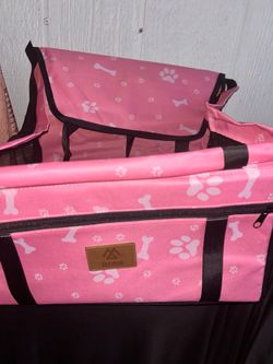 Elevon pet booster seat features a vibrant pink fabric printed with white bone and paw icons