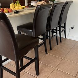 4 Costco barstools dark brown vinyl with metal studding along chair base
