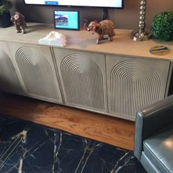 HIGH END TV STAND UP TO 85 INCH OR BUFFET OR ANY USE…MERCANA TUCKER LIGHT BROWN WOOD W/CARVED ARCH PATTERN 4 DOOR SIDE BOARD PLEASE READ DISCRI