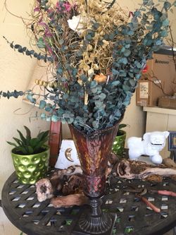 Large flower arrangement in metal vase