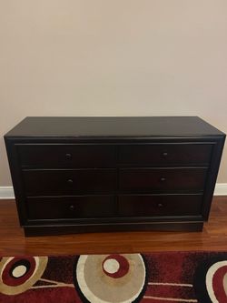 Dark brown 3 piece bedroom set includes bed, 5 drawer tall dresser, and 6 drawer short dresser.