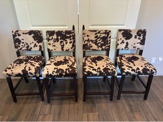 4 brown and cream cowhide ranch style chairs