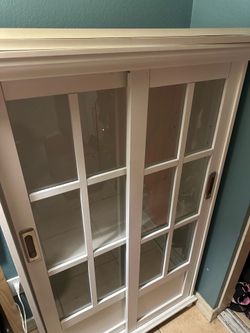 White bookcase with sliding doors
