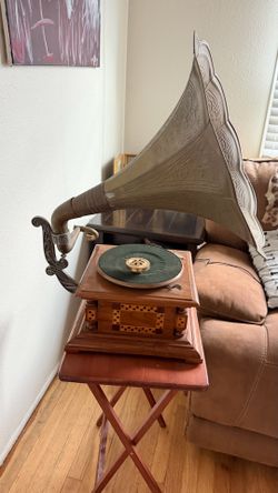 Antique gramophone has ornate brass horn