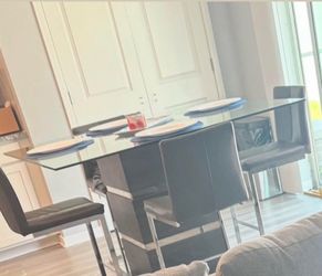 Modern dark gray glass table top with chairs