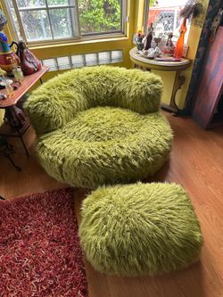 Green shaggy soft chair and foot rest