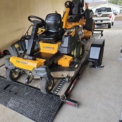 2 Cub Cadet 60 Inch Cut Zero Tutns With Sterring Wheel .and 14 Foot Eagle Roll Back Trailer 